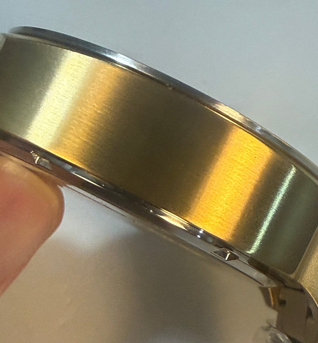 Close-up of a gold Invicta Speedway 48mm with a plain background