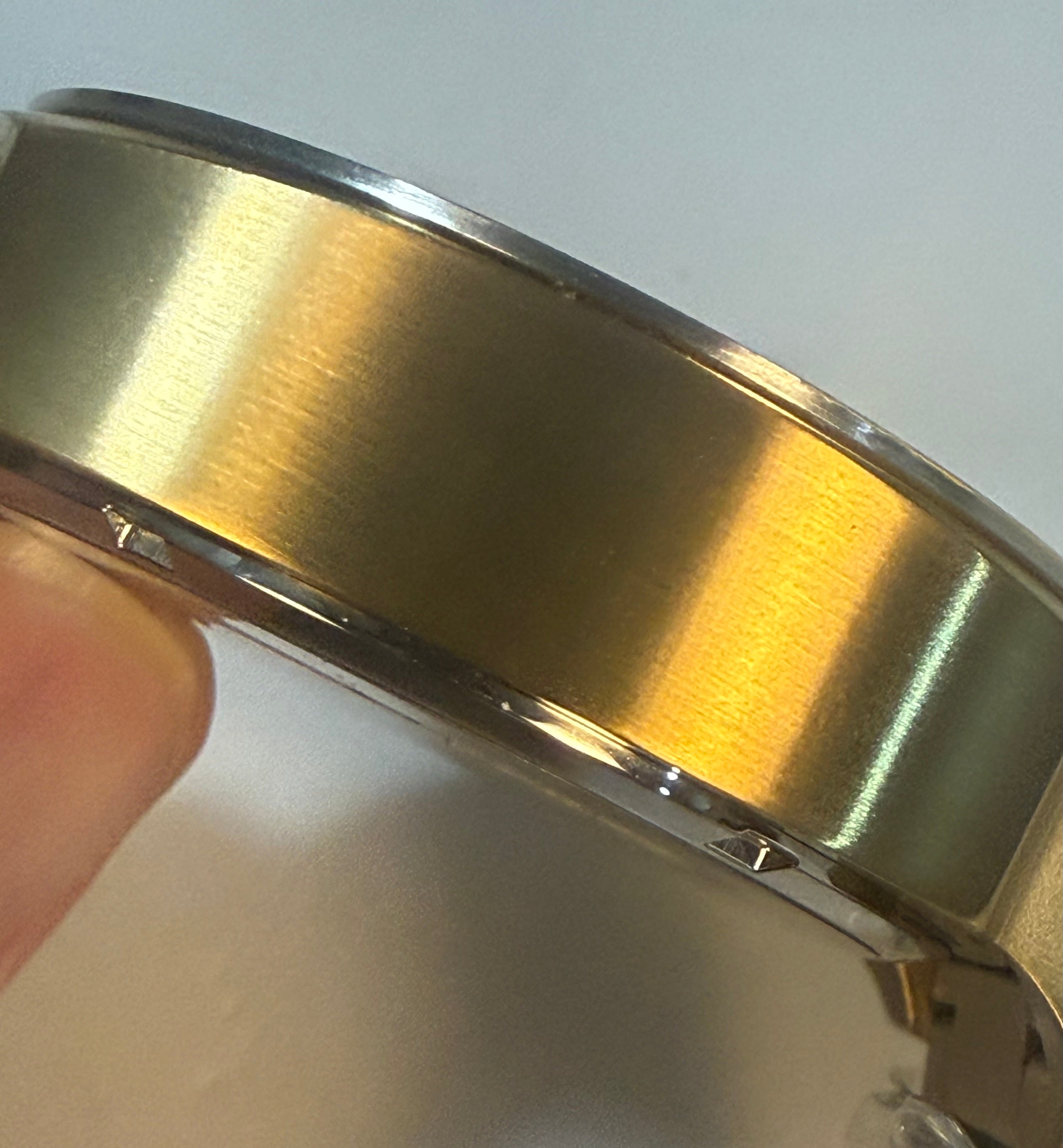 Close-up of a gold Invicta Speedway 48mm with a plain background