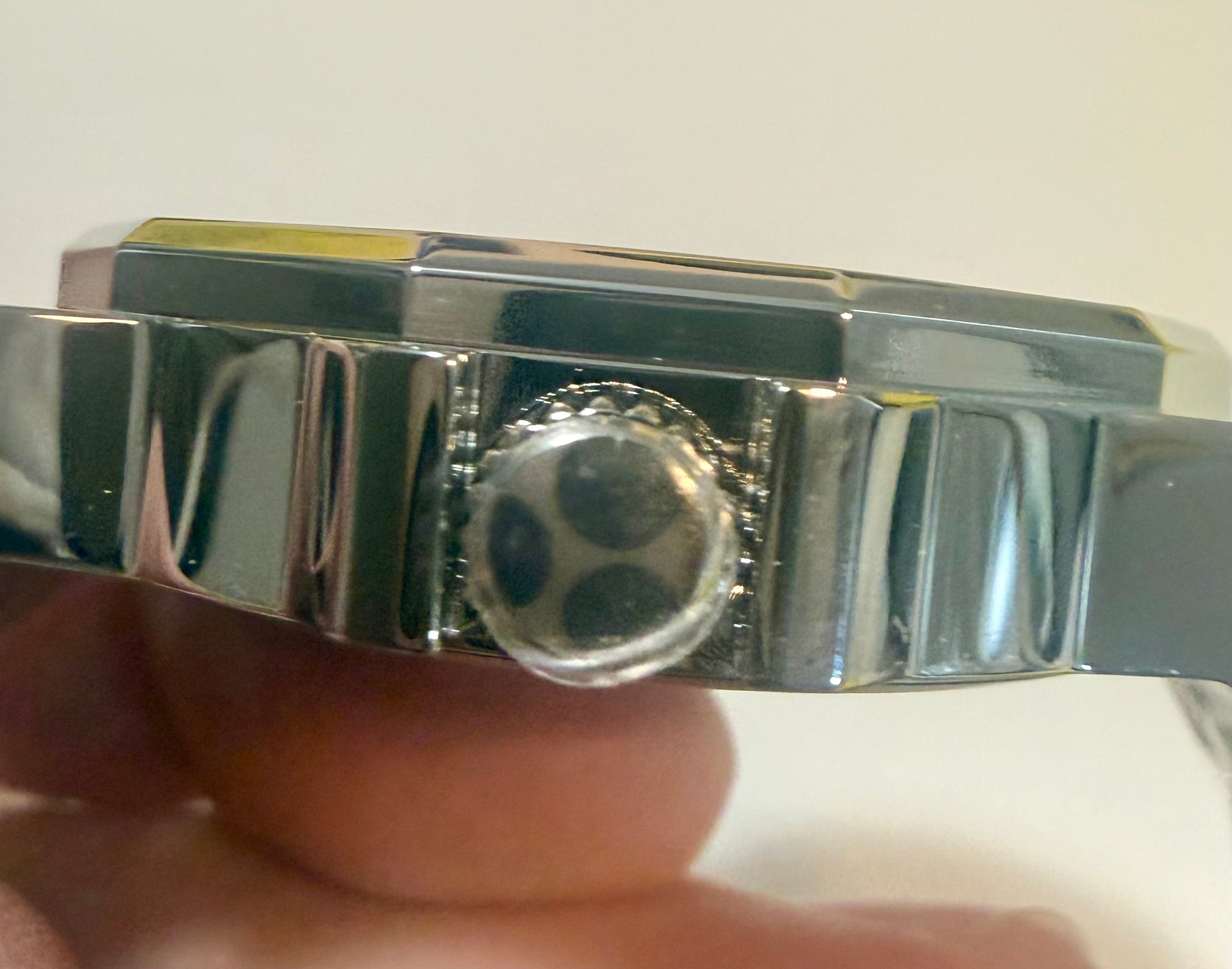 Close-up of a Invicta Speedway 42mm Mens Watch held by a hand against a neutral background