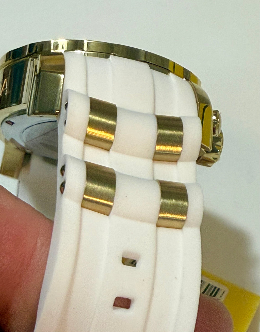 Close-up of a Invicta Pro Diver SCUBA Men's Watch - 48mm. Gold, Whiteheld by a hand on a white background