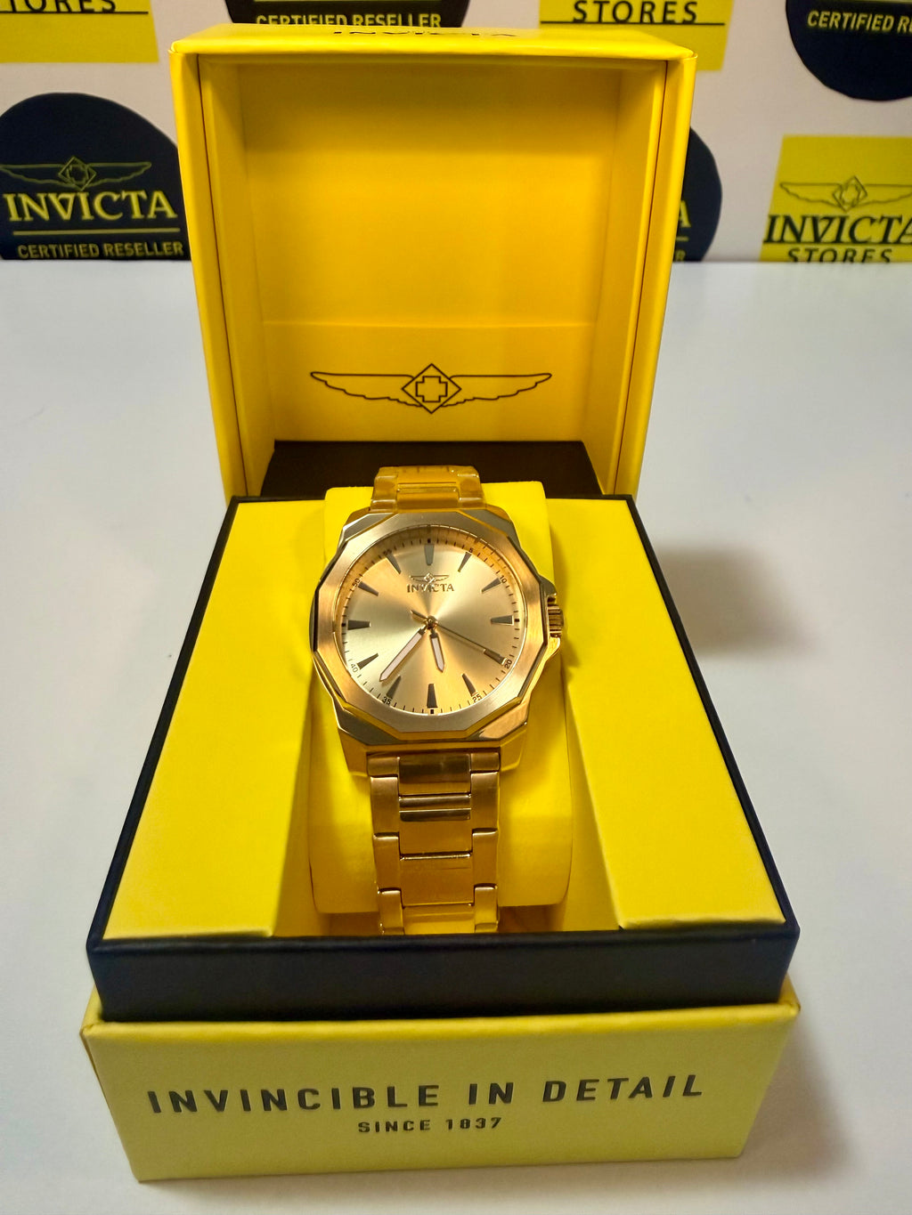 Invicta Speedway 46840 Gold Dial Gold Plated Steel 42mm Quartz Men's Watchin a yellow box with 'Invicta' branding.