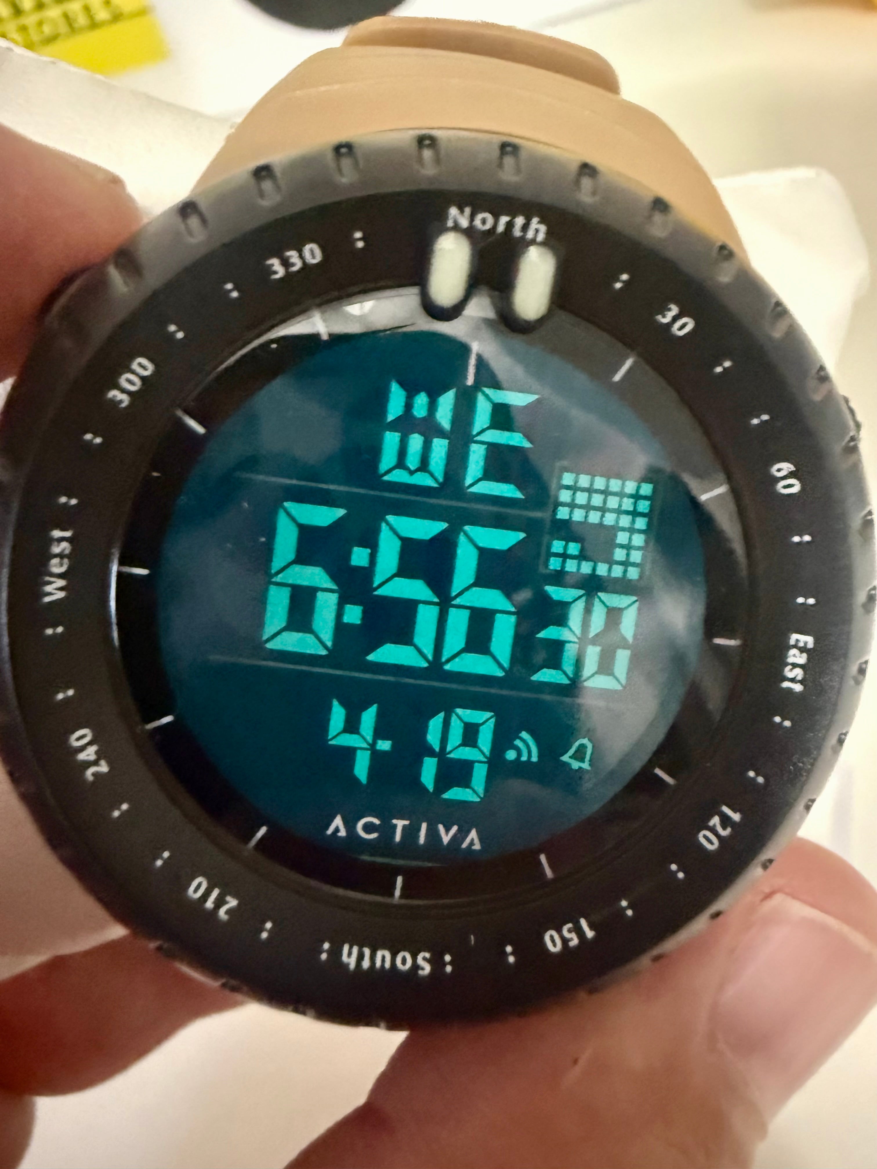 Activa X Odyssey Digital watch with compass functions held in a hand