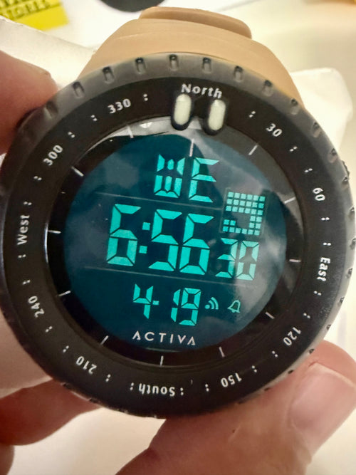 Activa X Odyssey Digital watch with compass functions held in a hand