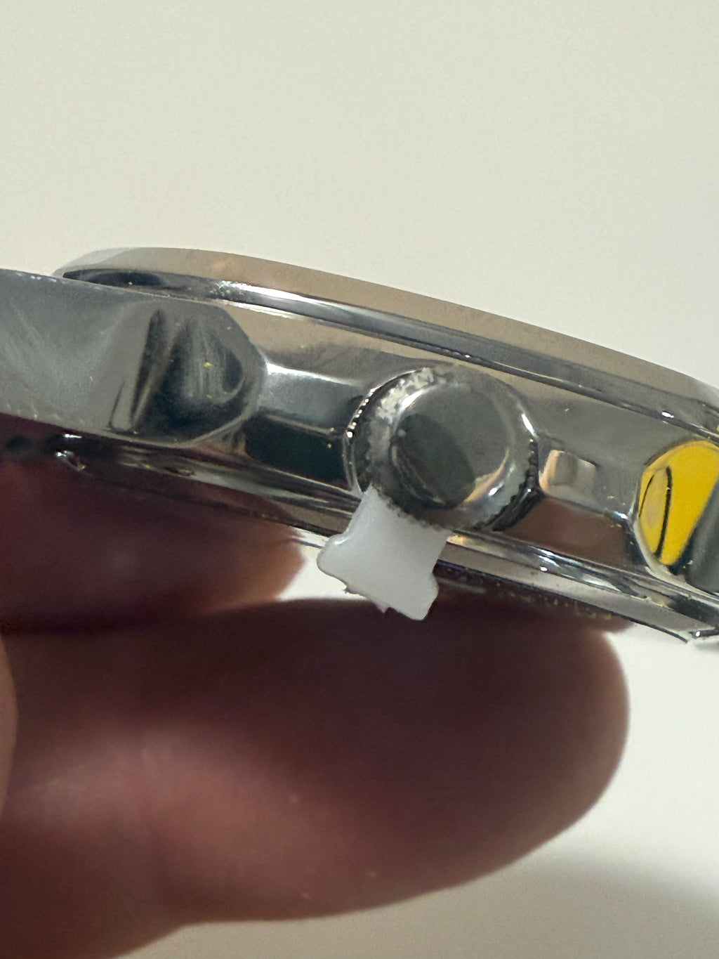 Close-up of a Invicta Speedway Vantage Men's Watch - 43mm. Steel with a hand holding it against a neutral background
