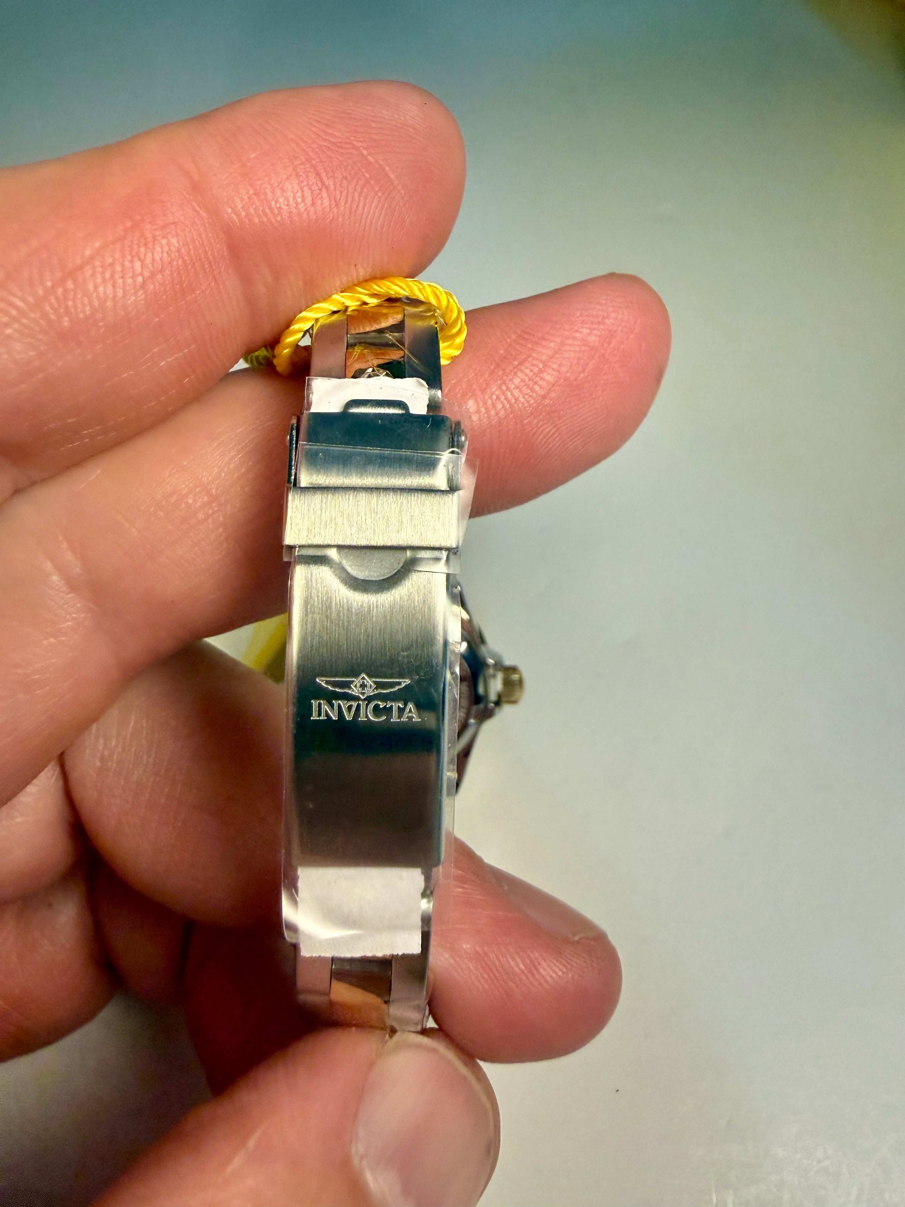 Ladies Invicta Pro Diver 24.5 mmInvicta watch held in a hand with a plain background