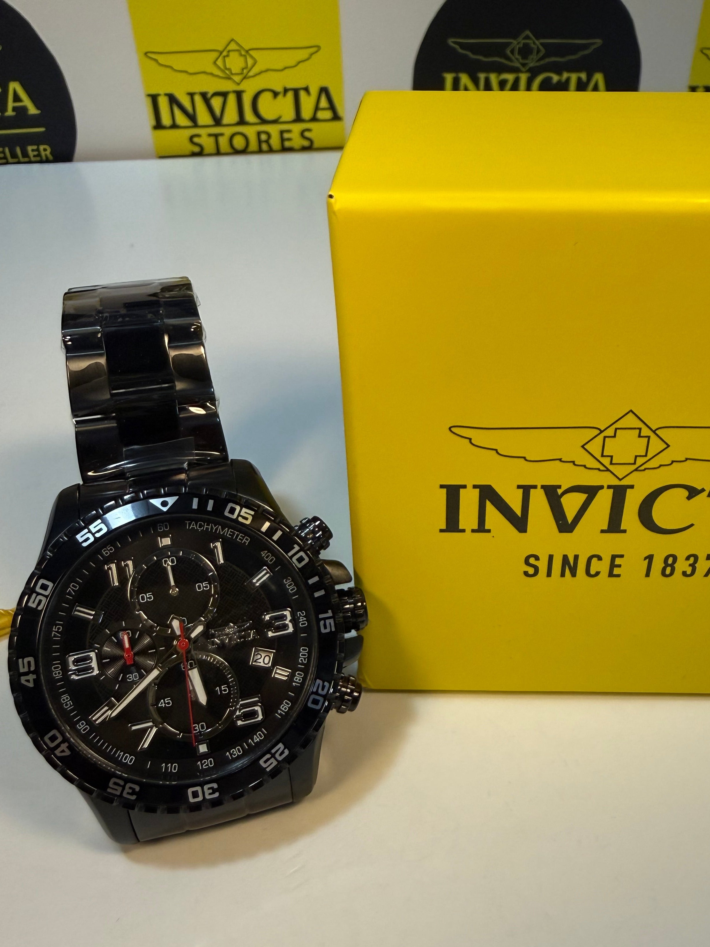 Invicta Mens Specialty Fortitude watch on a white surface with a yellow box in the background