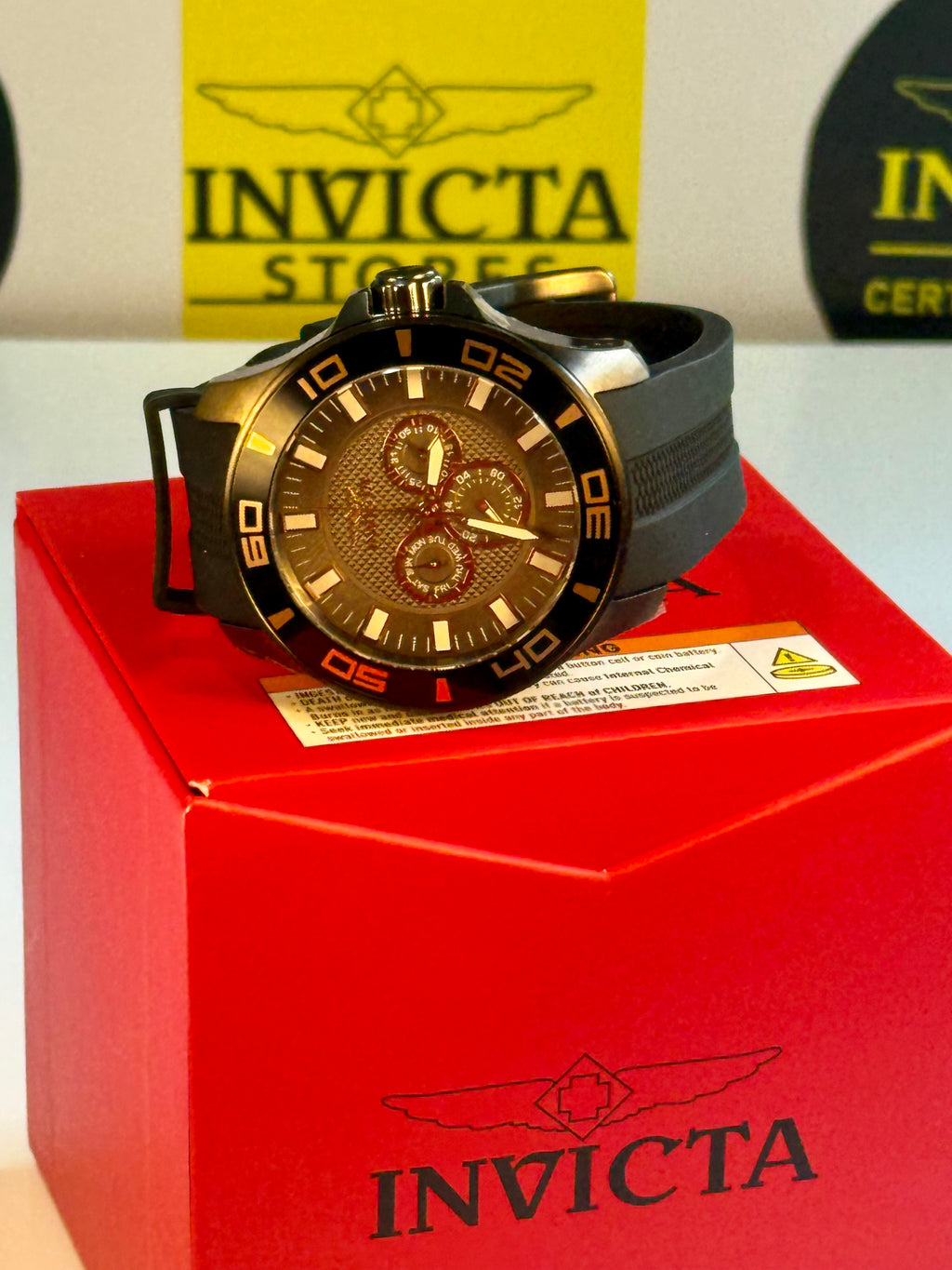 Invicta Mens Pro Dvider Chronograph watch on a red box with brand logo in the background