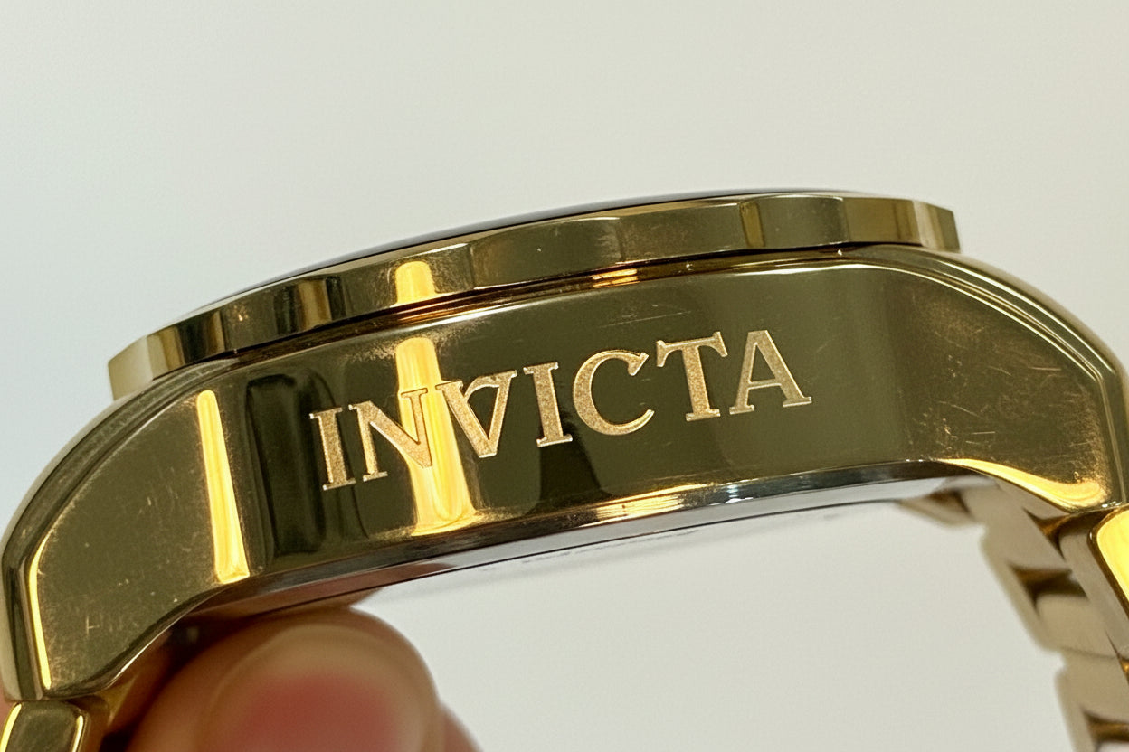 Invicta Pro Diver SCUBA Men's Watch - 48mm. Gold, White watch band with a person's hand holding it against a white background