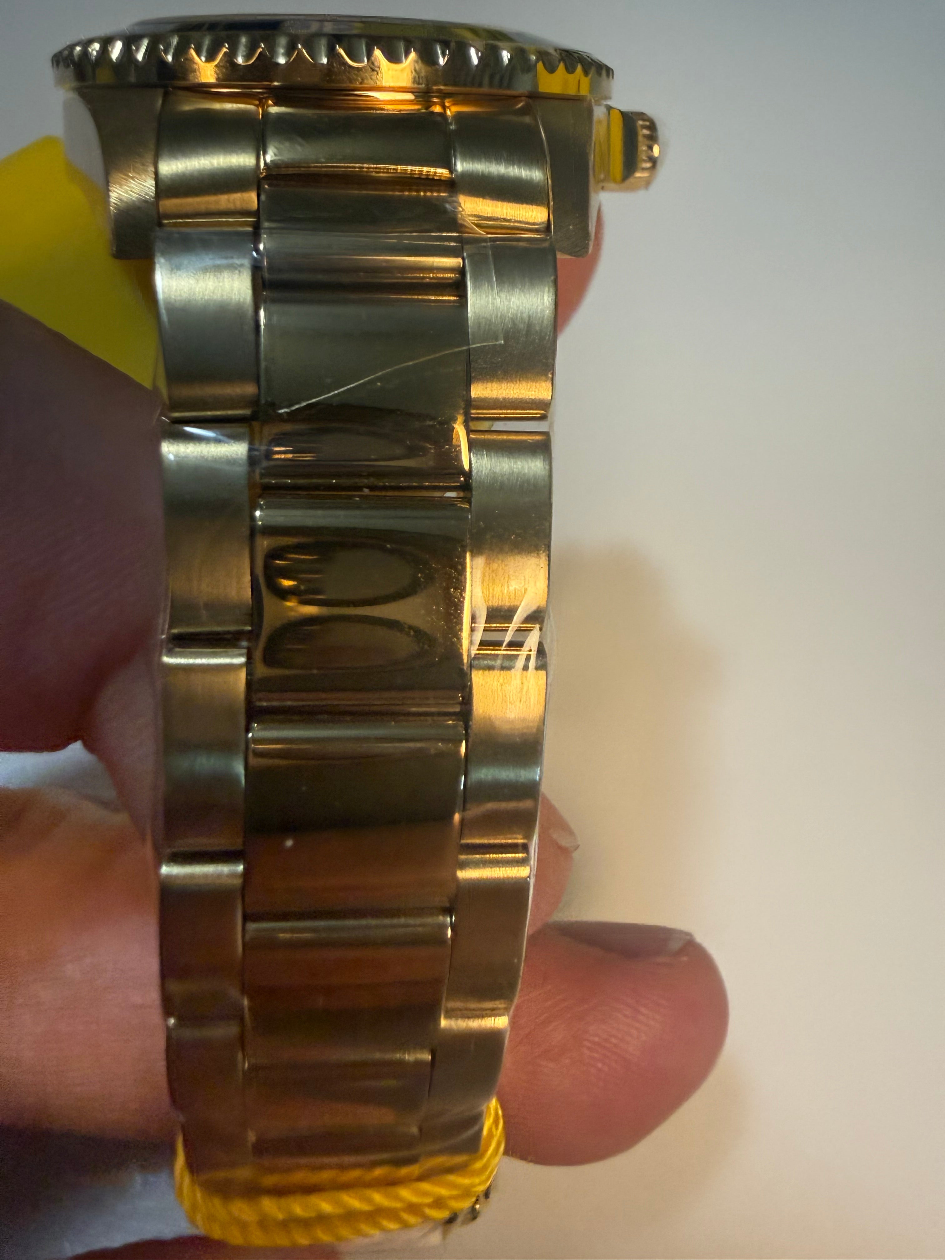 Invicta 38mm Unisex Pro Diverwatch band held by a person against a neutral background