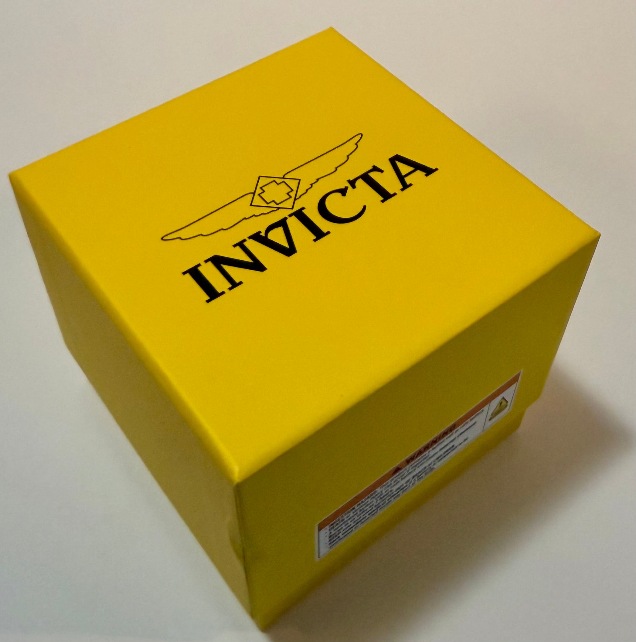 Yellow box with 'Invicta' branding on a white background