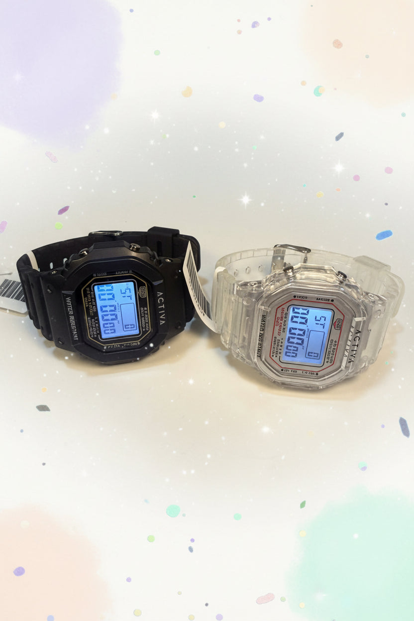 Activa ebony and Ivory Bundle Two digital watches, one black and one clear, on a white surface with an Invicta store sign.