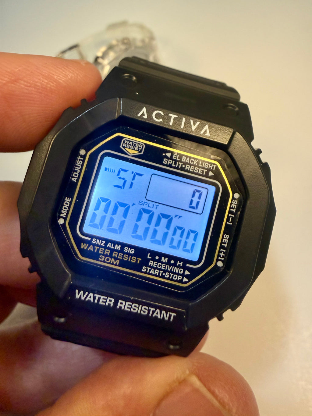 Activa ebony and Ivory Bundle Digital watch with blue screen held by a hand, brand 'Activa' visible