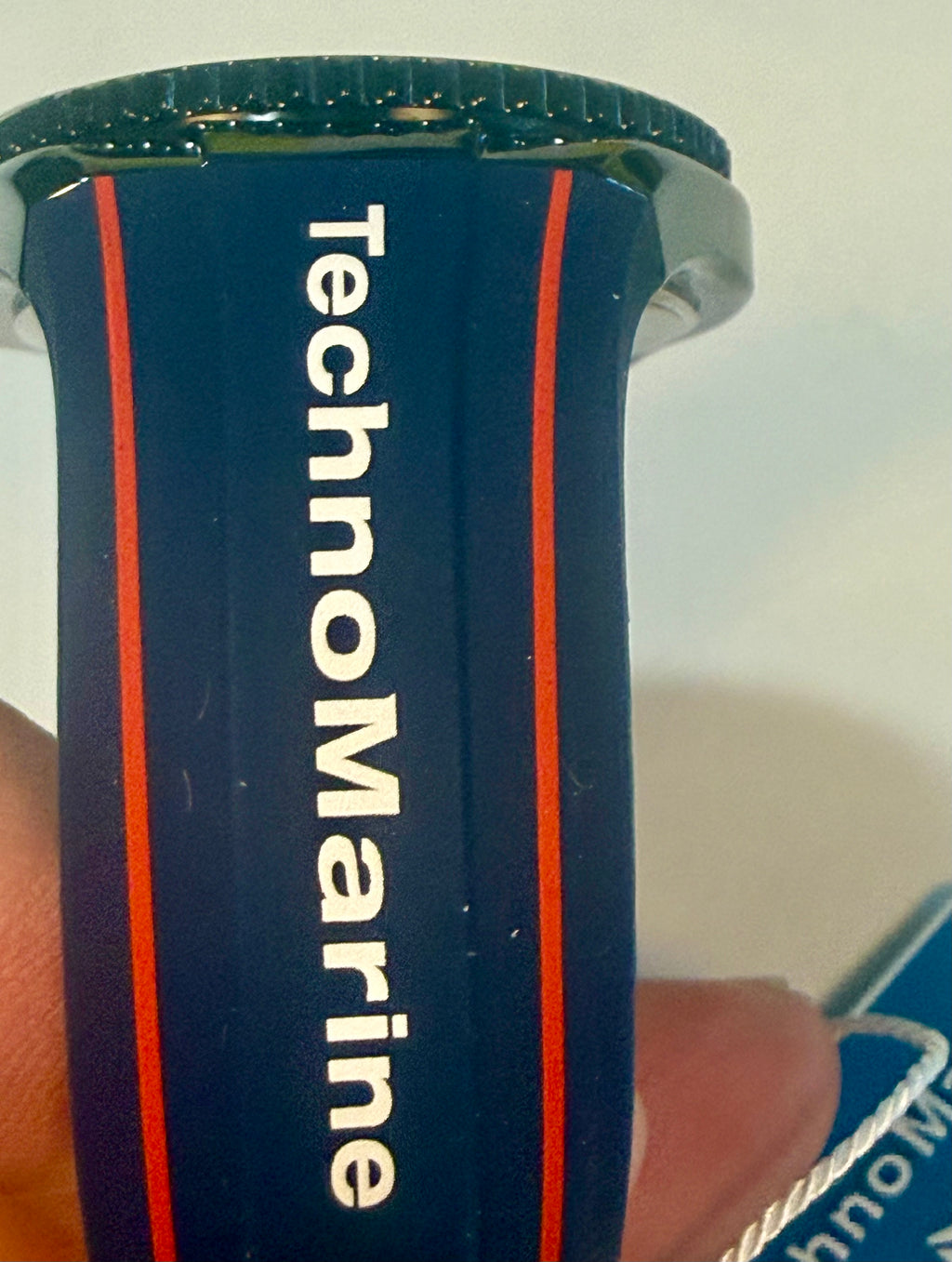 Close-up of a TechnoMarine watch band with a blue and red design.