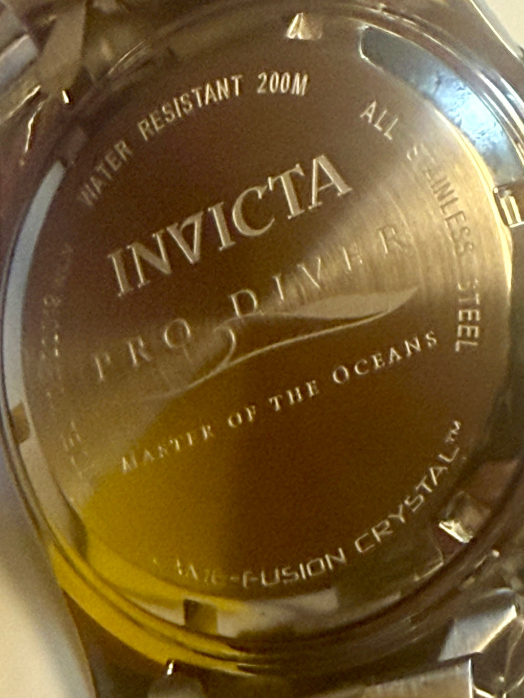 Invicta Pro Diver watch face with branding and specifications.