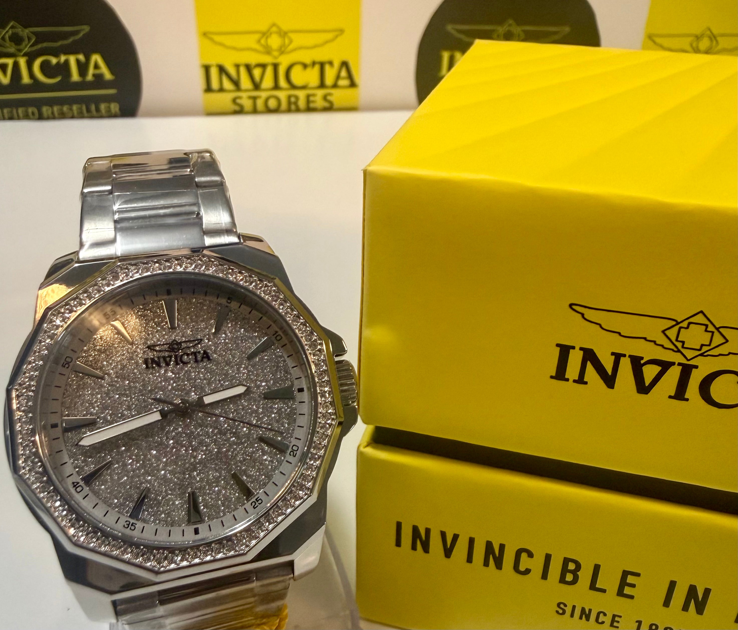 Invicta Speedway 42mm Mens Watch with decorative face next to a yellow Invicta box