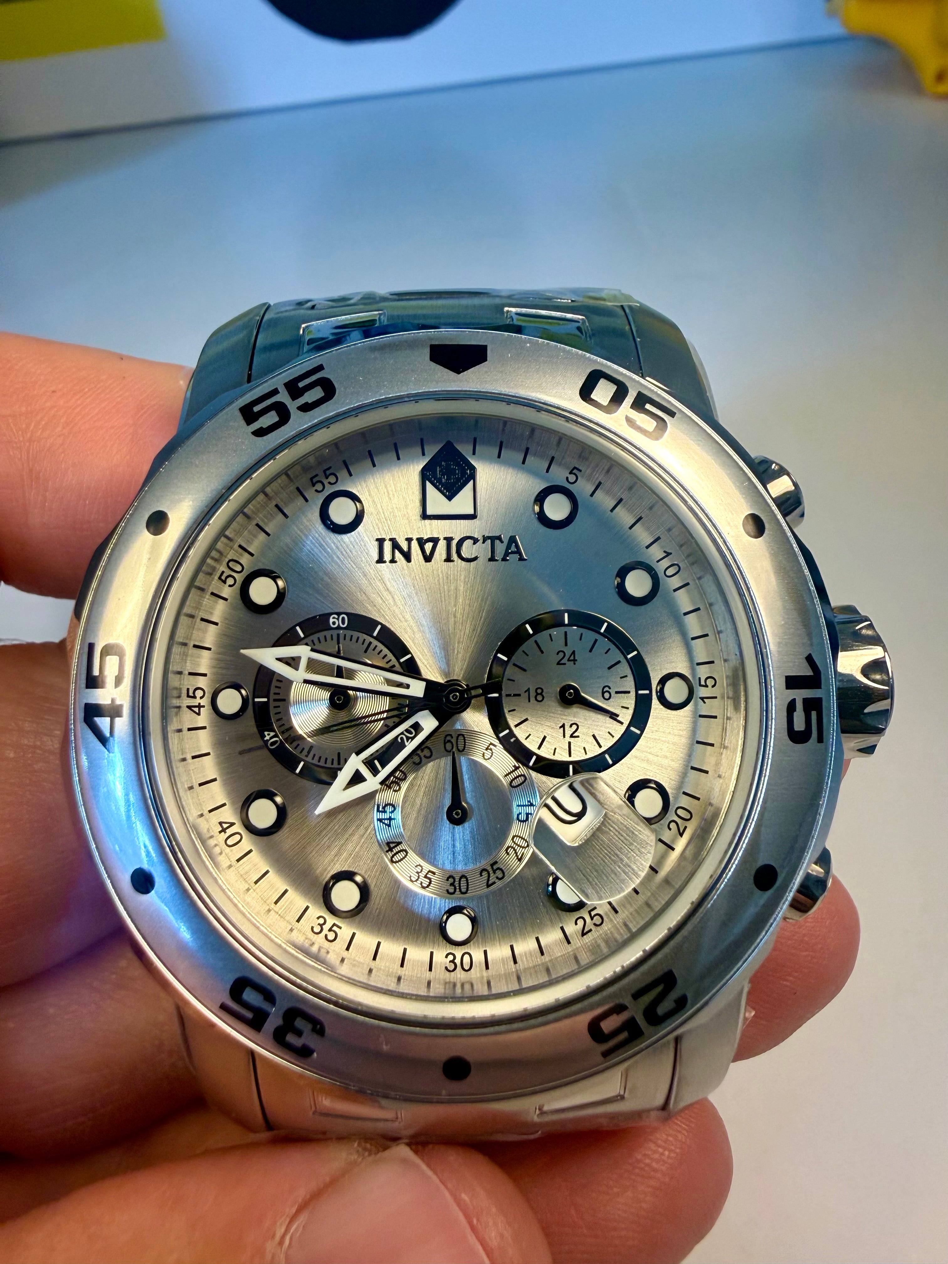Invicta Pro Diver Scuba 48mm watch held in a hand with a blurred background