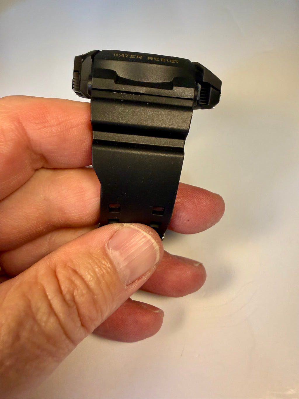 Invicta Activa Vord X strap held by a hand on a white background