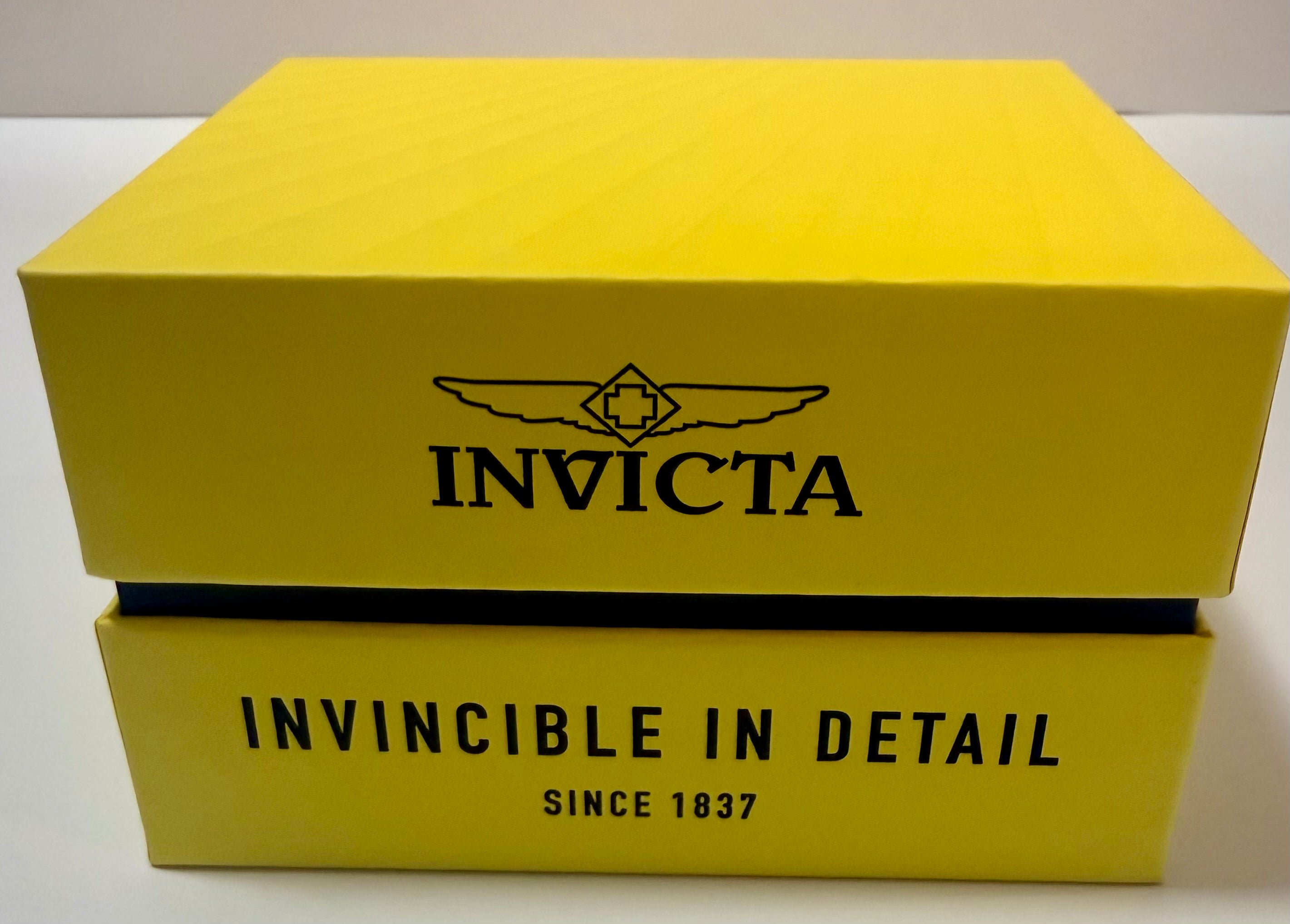 Yellow Invicta product box with brand logo and tagline on a white background