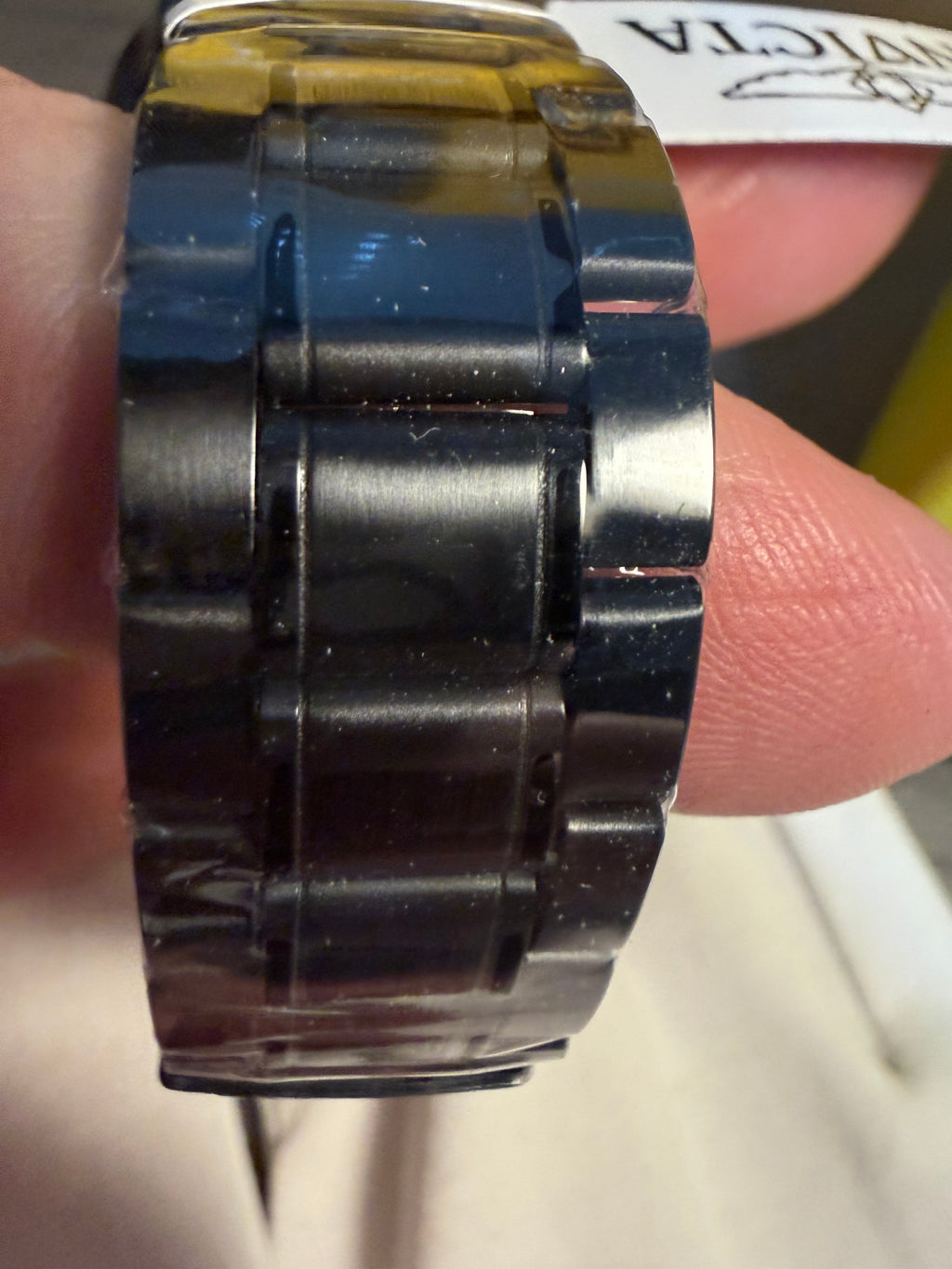 Close-up of an Objet De Art By Invicta watch band with a blurred background