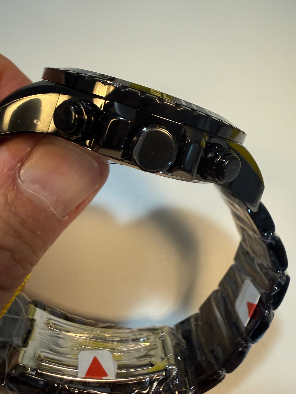 Close-up of a person holding a Invicta Mens Specialty Fortitude  with a blurred background