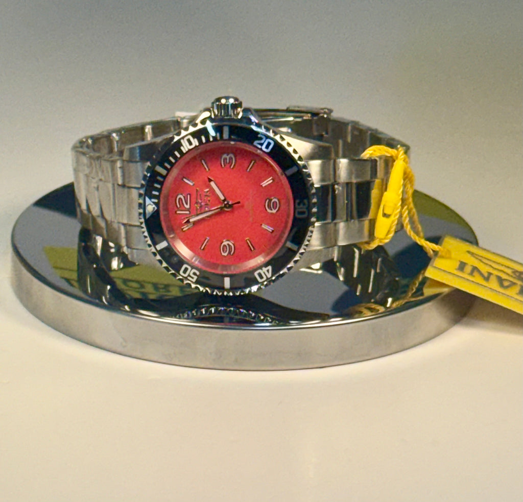 Invicta Specialty Rowan Silver watch with a red face on a reflective surface