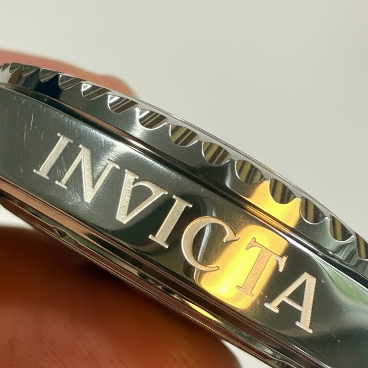 Close-up of aInvicta Mens Pro Diver 43mm Heritage  band held by a hand against a white background