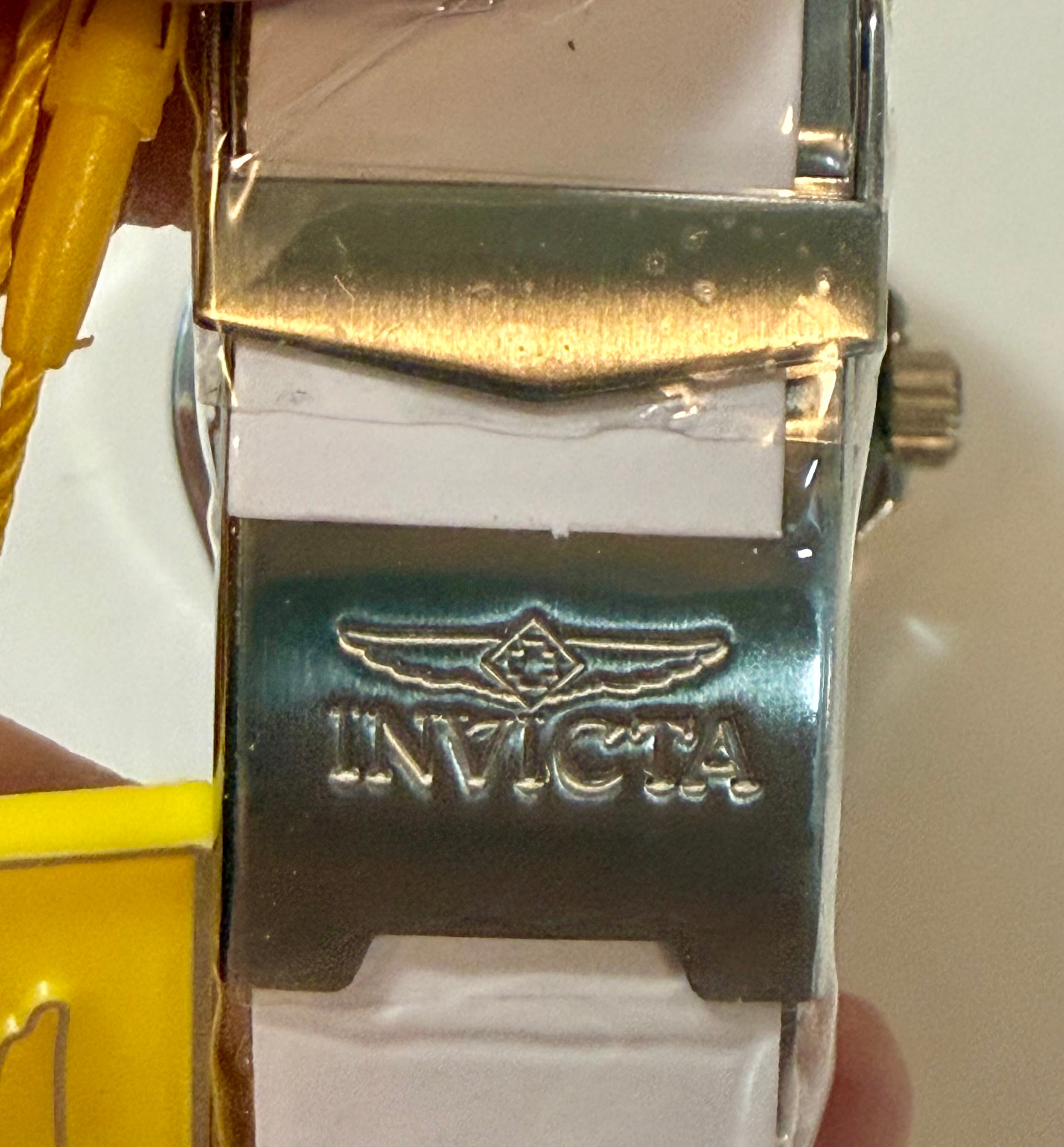 Close-up of a watch band with Invicta logo on a white background