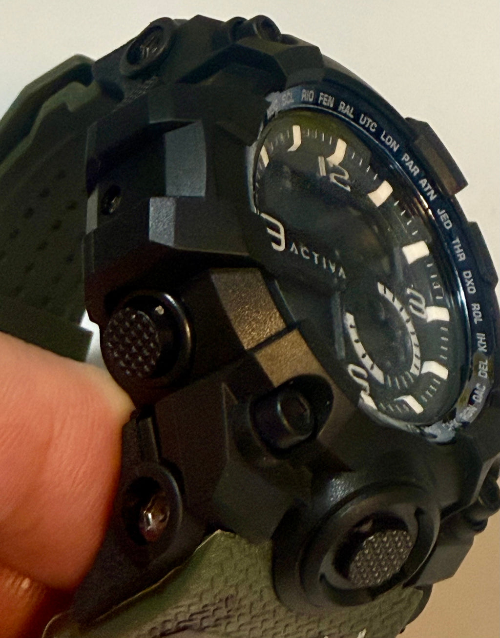 Activa Tactical X digital wristwatch with multiple functions held by a hand
