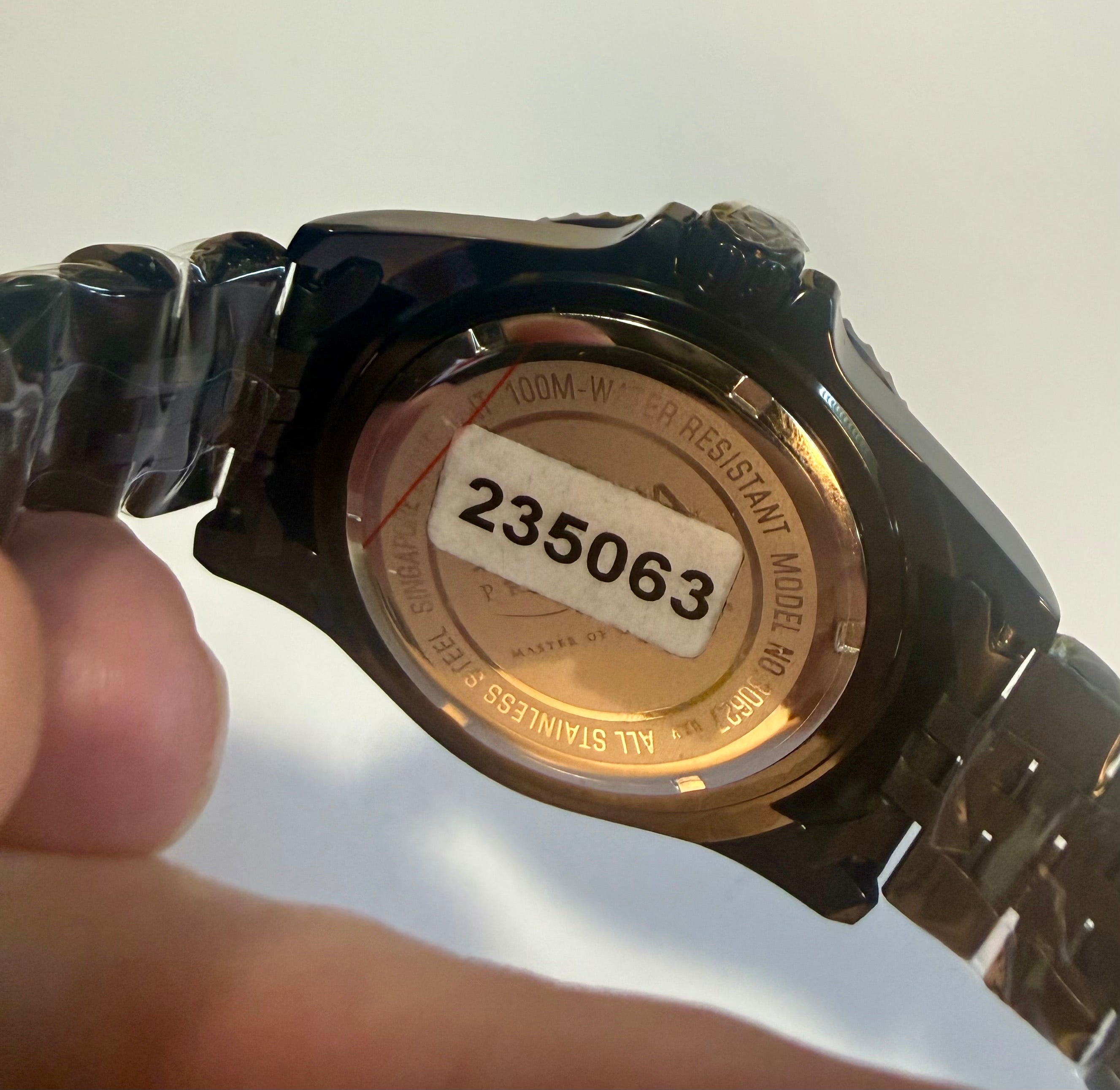 Close-up of aInvicta Mens Pro Diver Black and blue  case with a visible serial number on a white background