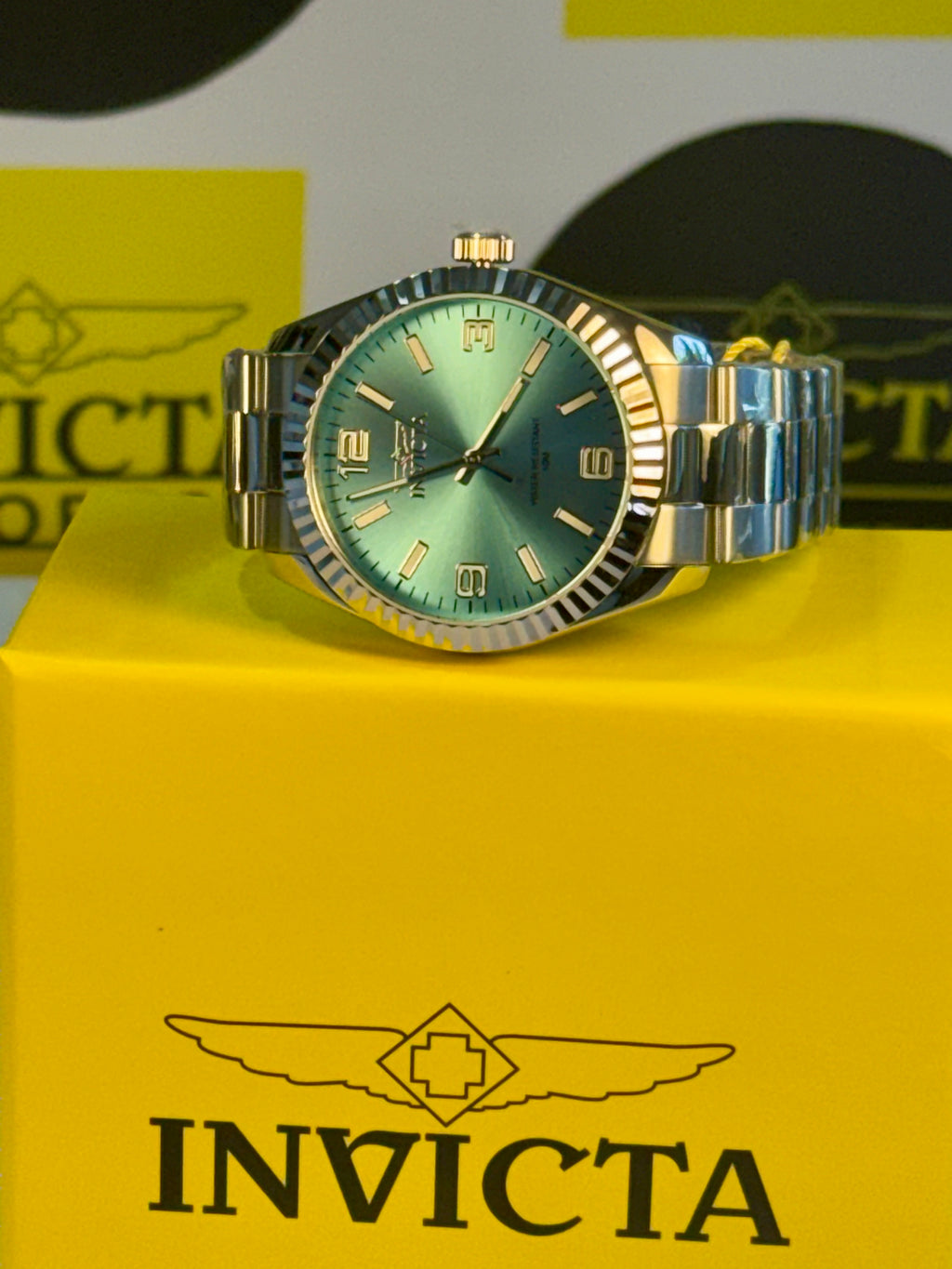 Invicta Specialty Stratford watch with green face on a yellow Invicta box