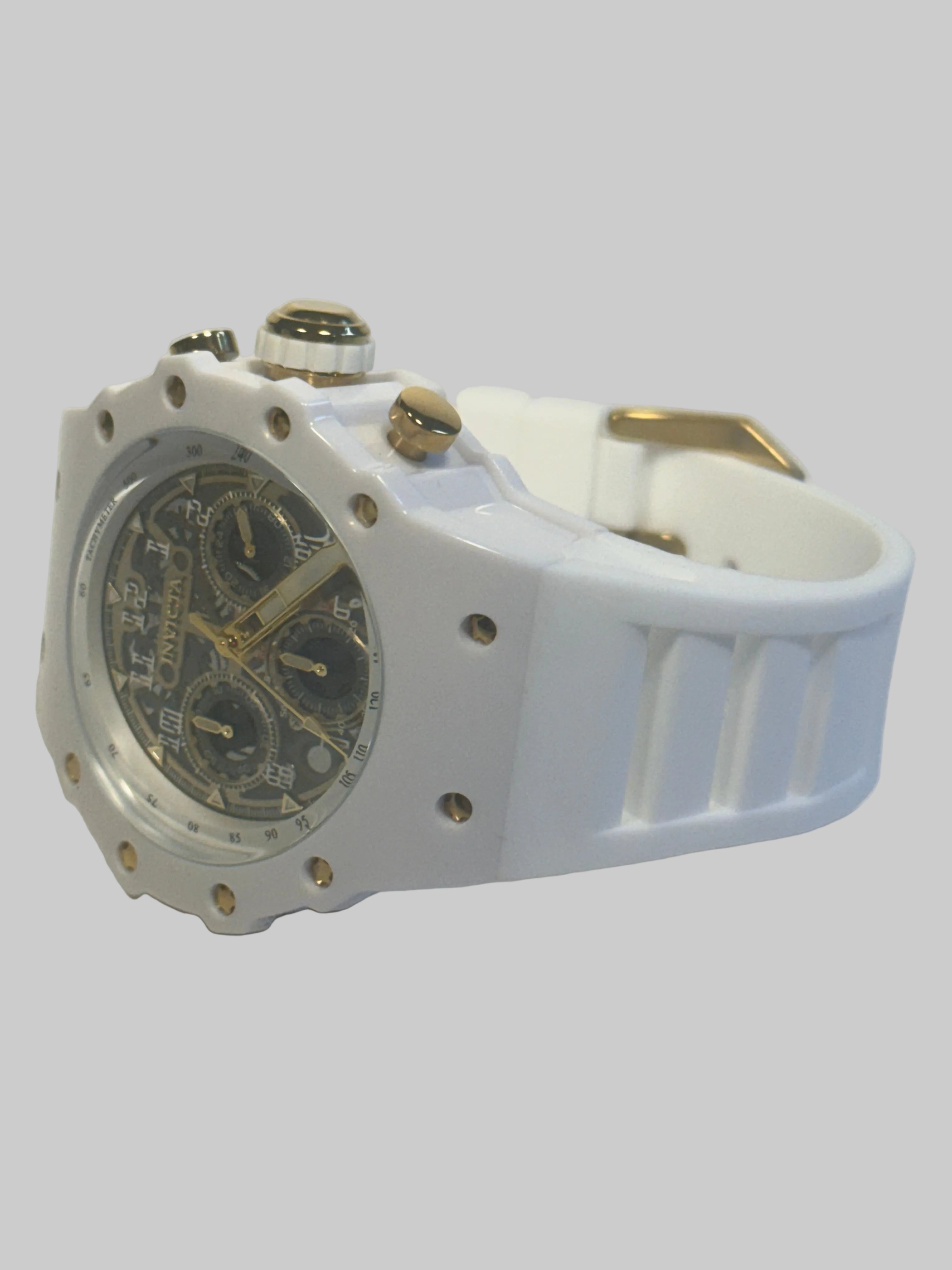 Invicta Men's Racing 43.5mm Quartz Watch IN-69649 Gold Dial White Silicone Strap lying on a flat surface