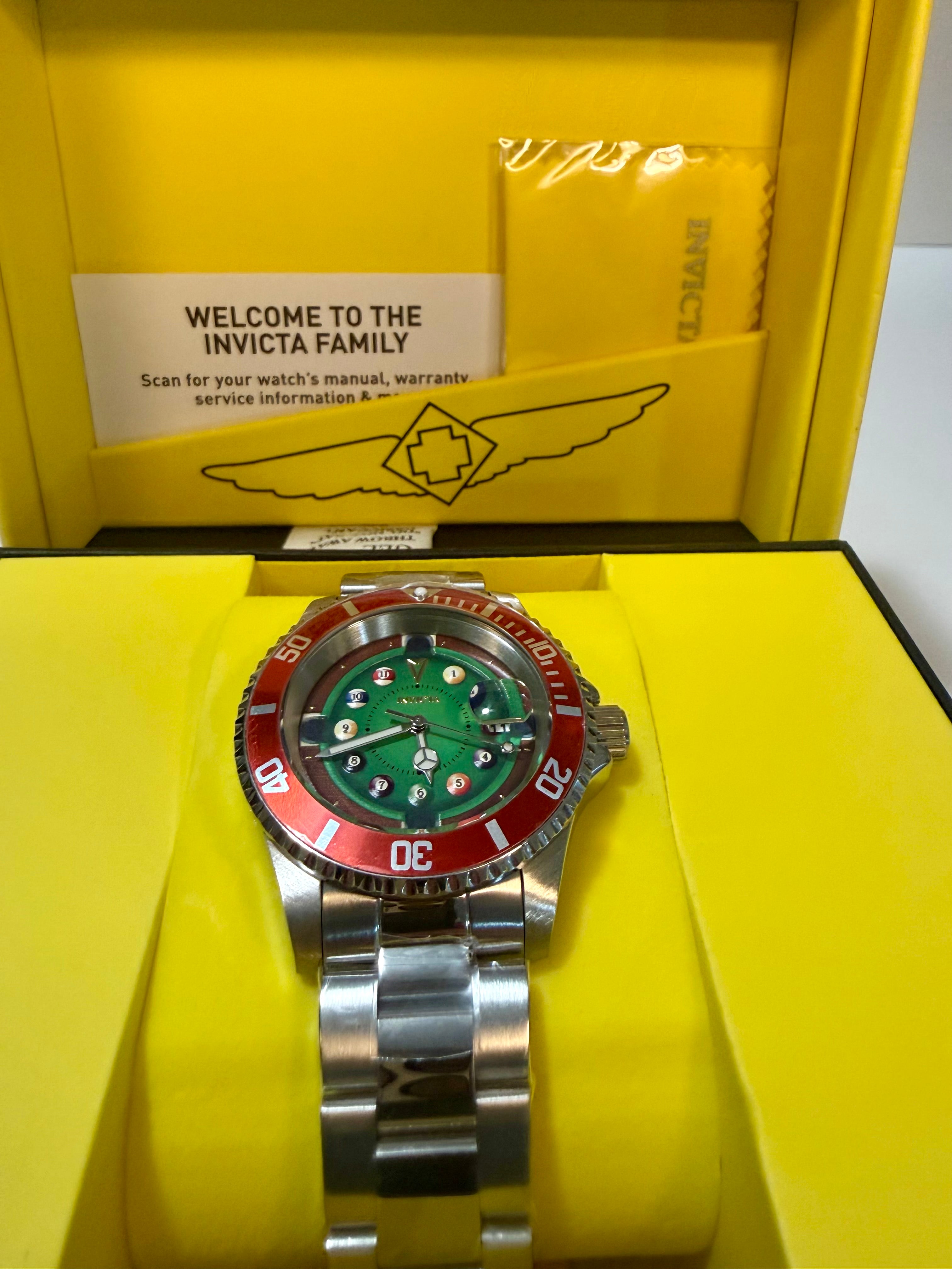 Invicta Pro Diver House of Cards Men's Watch - 40mm. with a green face and red accents on yellow Invicta packaging