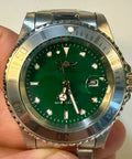 Invicta Mens Pro diver Aurenova 40mm Green watch with silver case held in hand against a white background