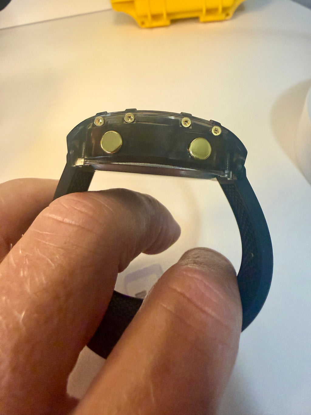 Close-up of a person holding aActiva X Ranger Bundle device with a blue strap.