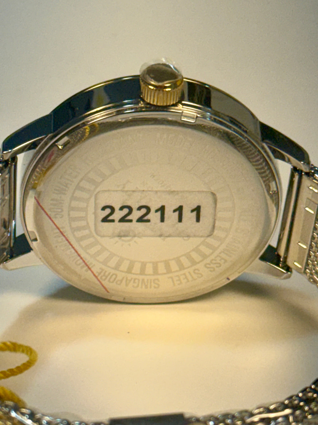 Invicta Mens Specialty Gold and silver watch with a visible serial number on a white background