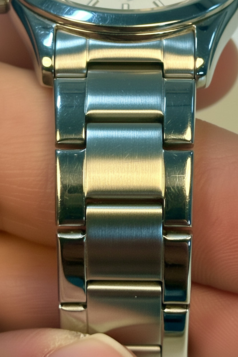 Close-up of aInvicta Ladies Celestial I  band held between fingers