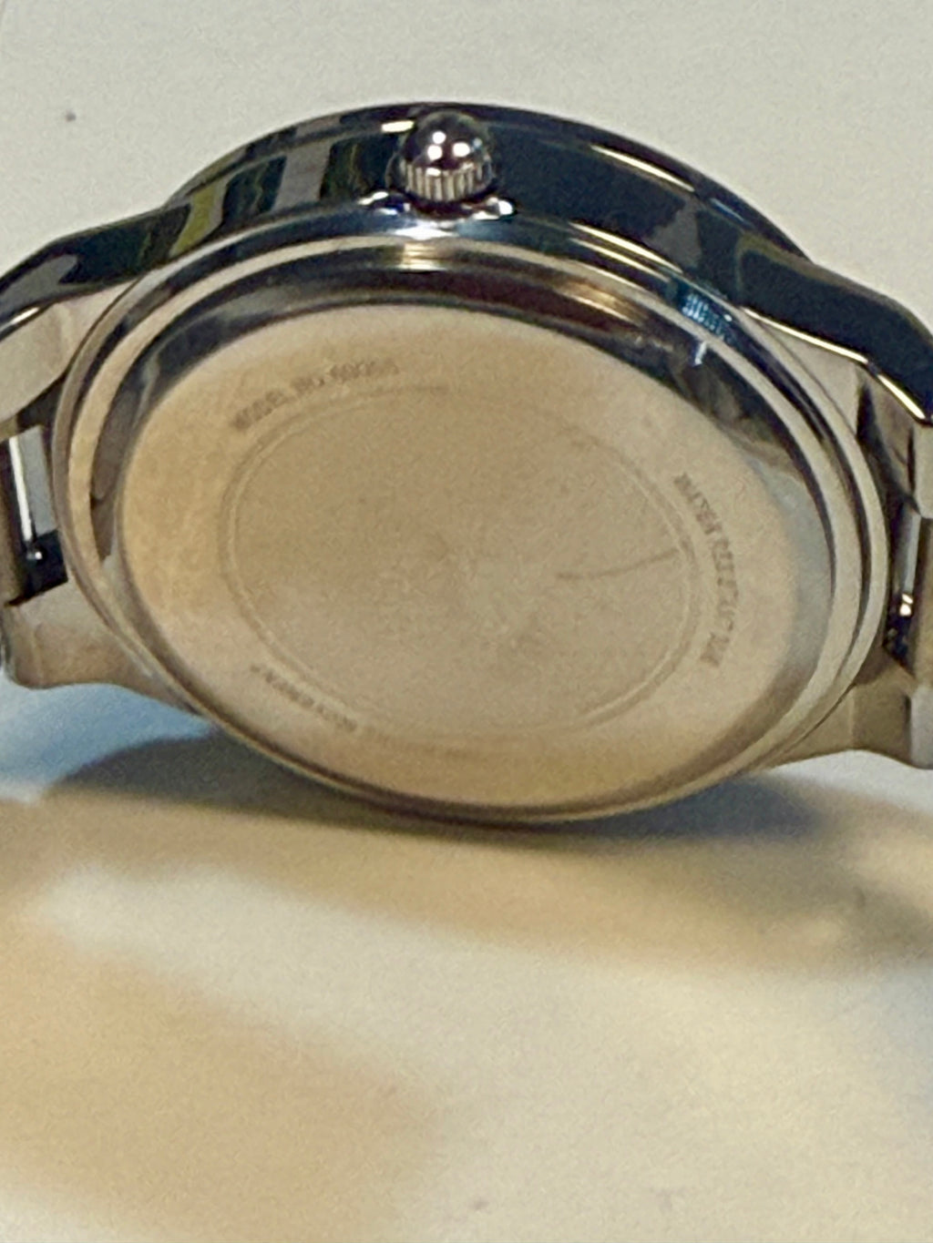 Back view of a watch on a light background