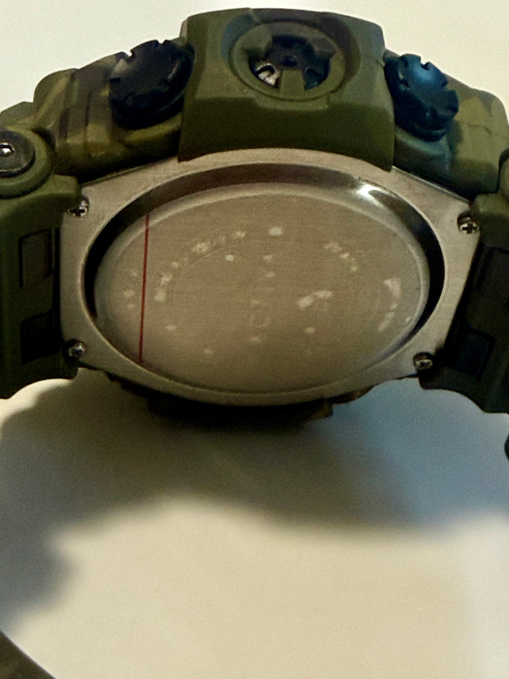 Close-up of a green Activa X By Invictawith a metallic face on a white background