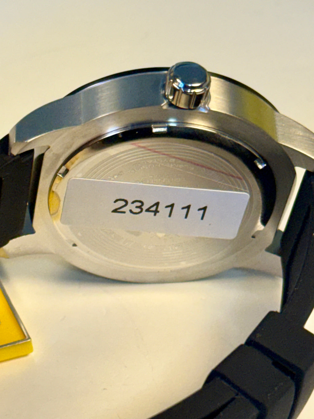 Invicta Specialty Compass Watch case with a visible serial number on a light background