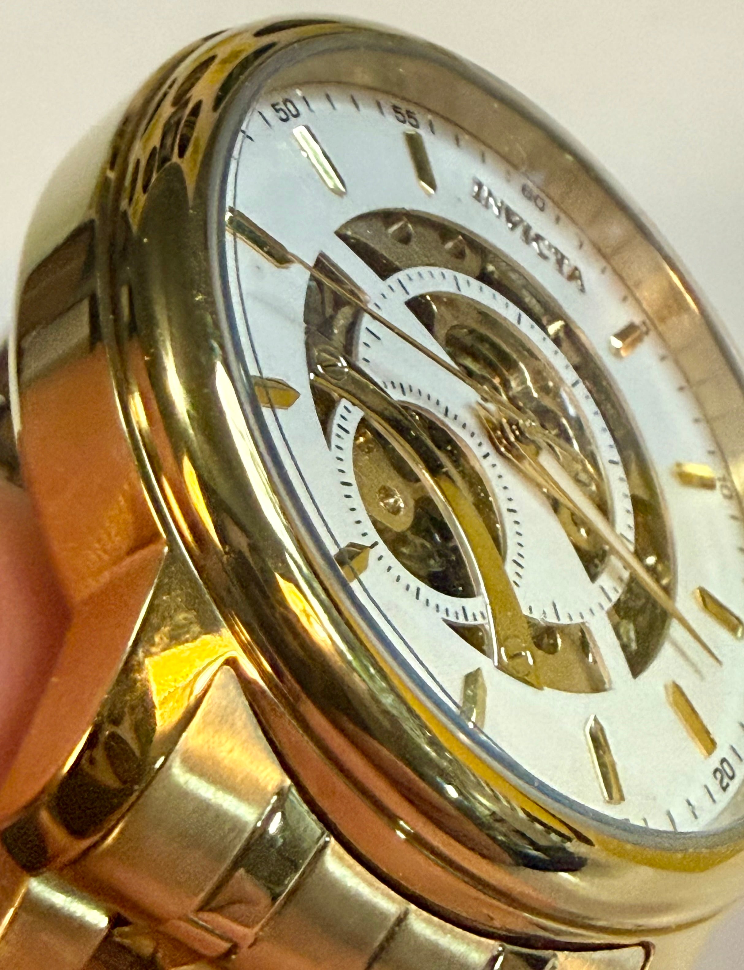 Invicta Mens Automatic Objet' De Art  Gold wristwatch with a visible brand name on a white background