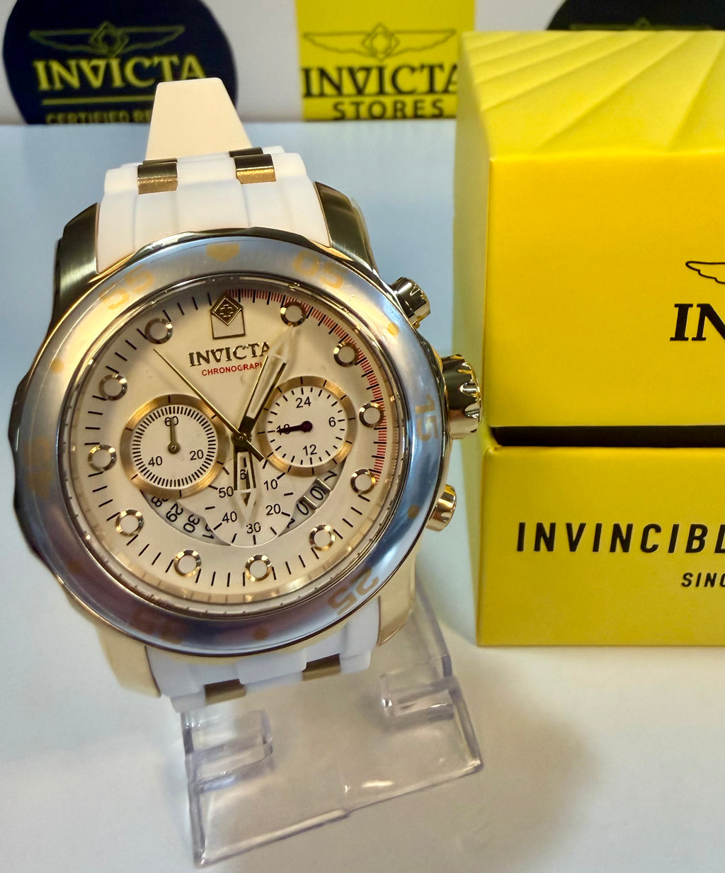 InvictaScuba 48mm watch on a stand with yellow box in the background