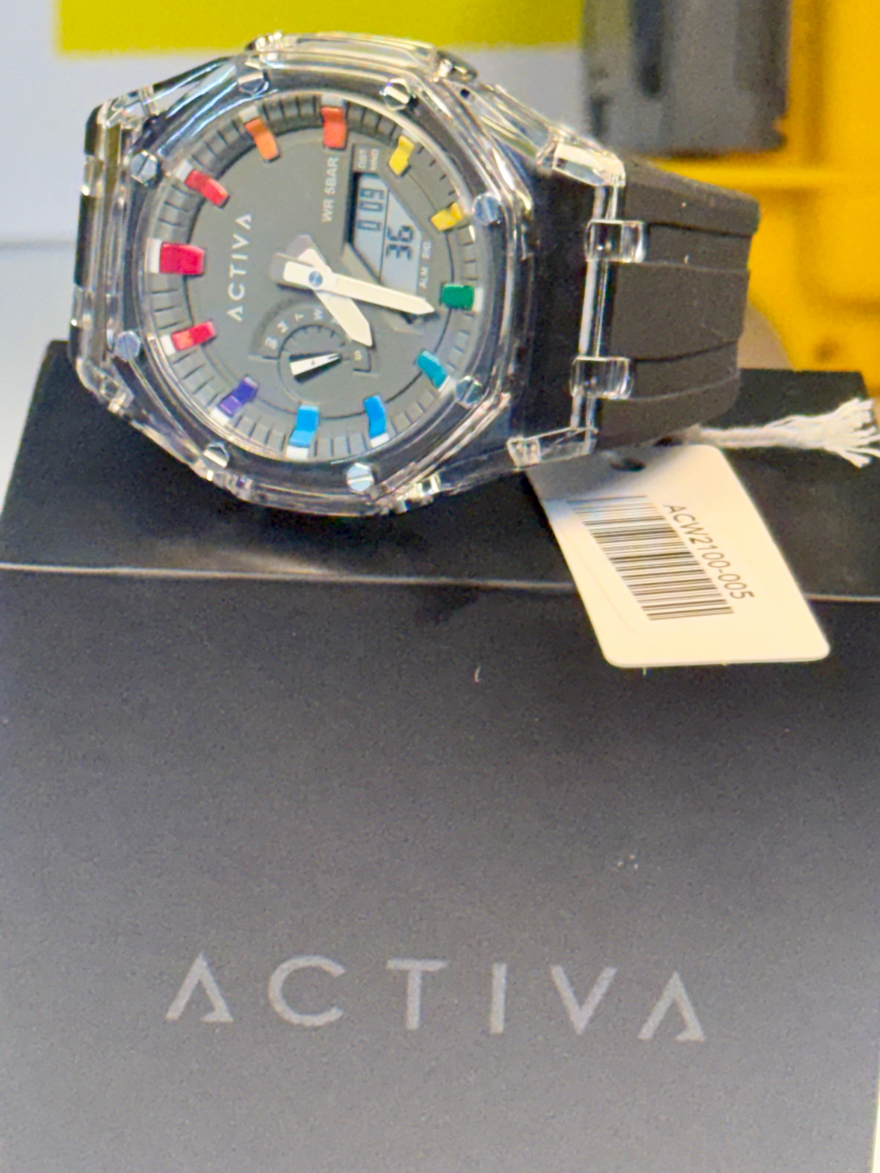 Activa Kaleido Rainbow  watch with colorful face on a black stand