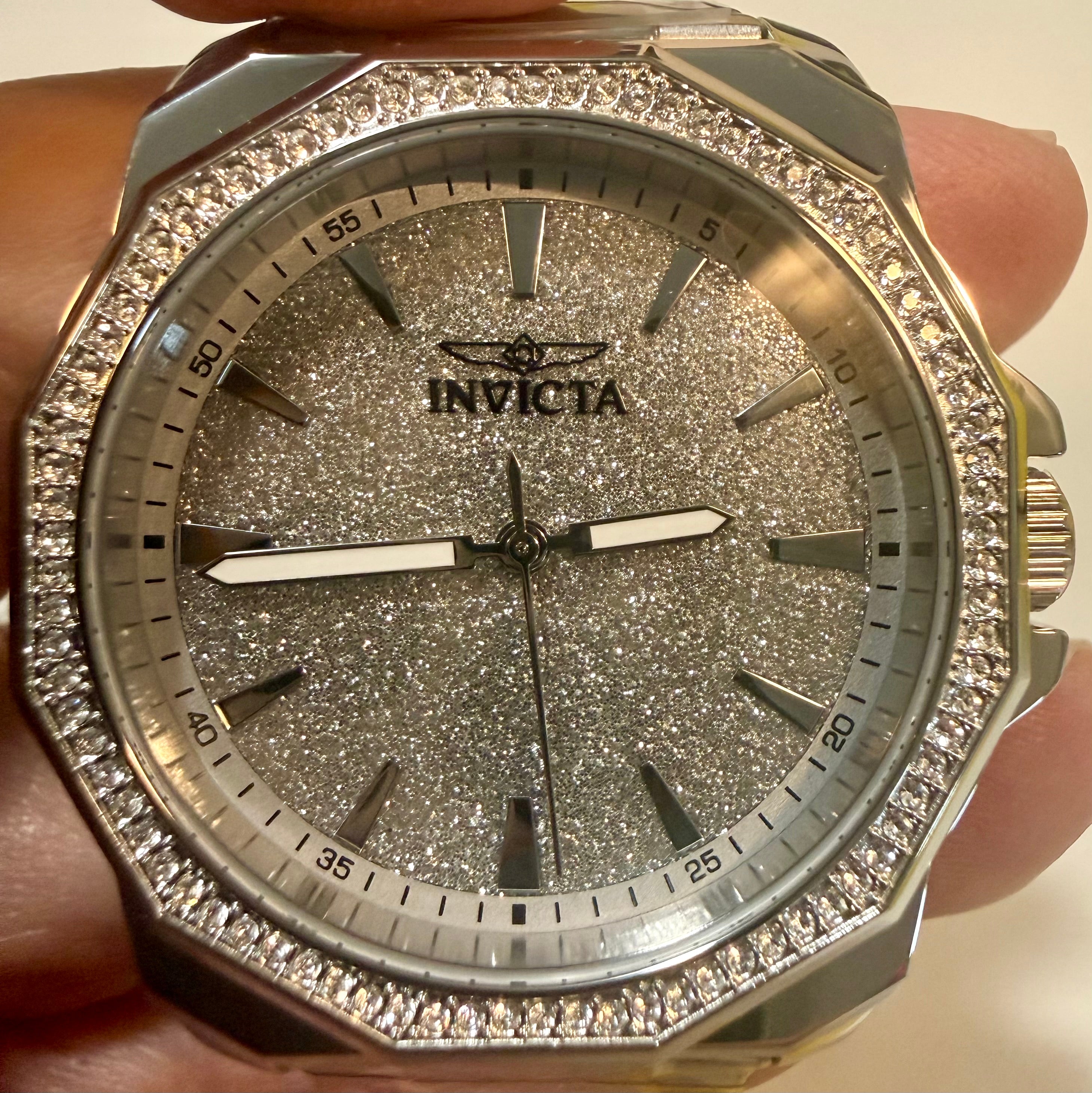 Invicta Speedway 42mm Mens Watch watch with glittery face and diamond-studded case held in hand