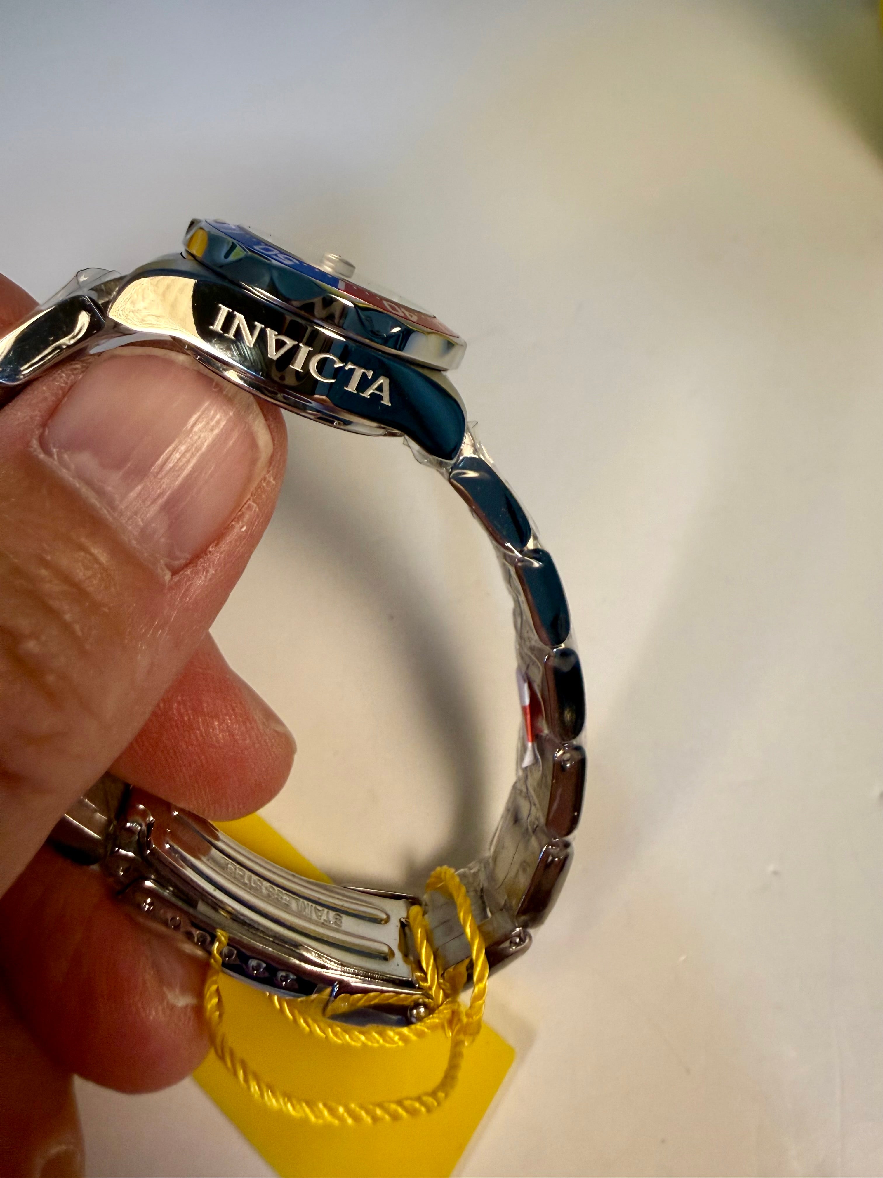 Ladies Pro Diver Invicta watch held by a hand with a white background