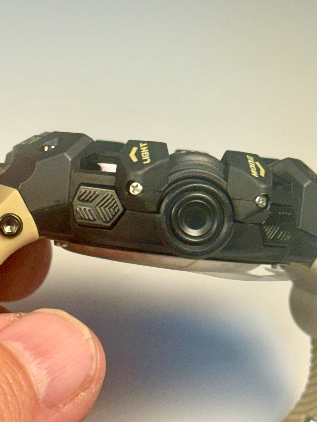 Activa Camo Sport Watch with tactical design held by a hand against a neutral background