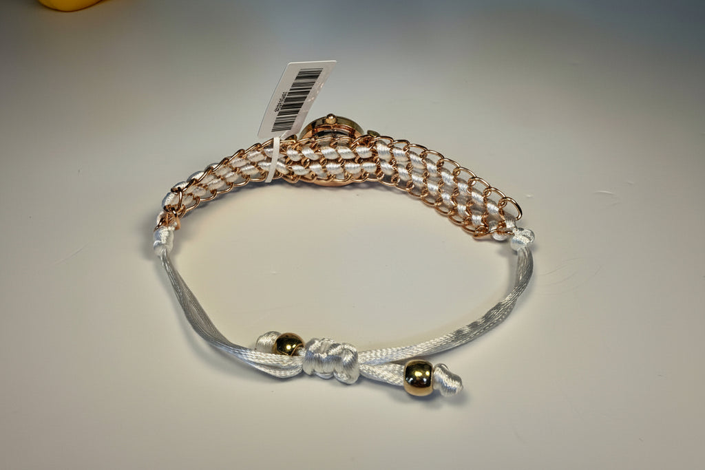 Ladies Montres Prestige with gold and silver beads on a light gray background