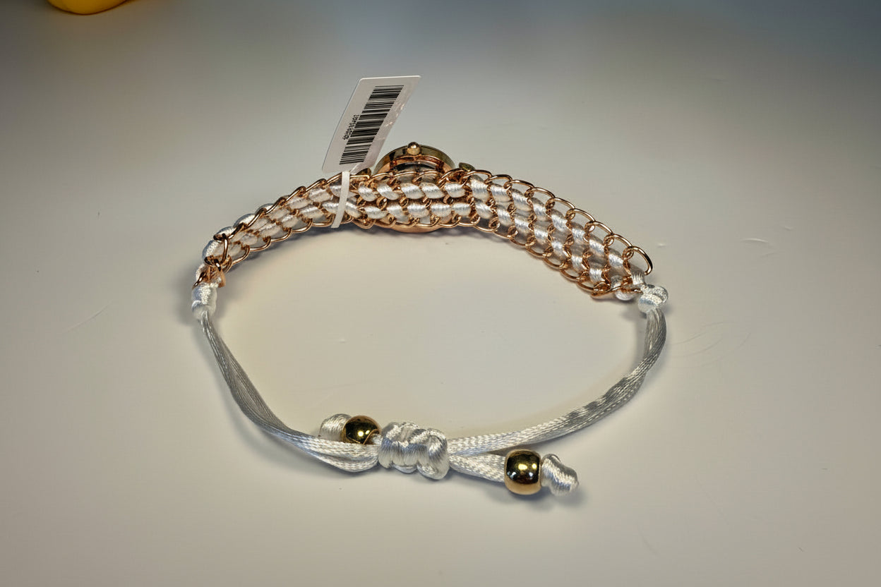 Ladies Montres Prestige with gold and silver beads on a light gray background