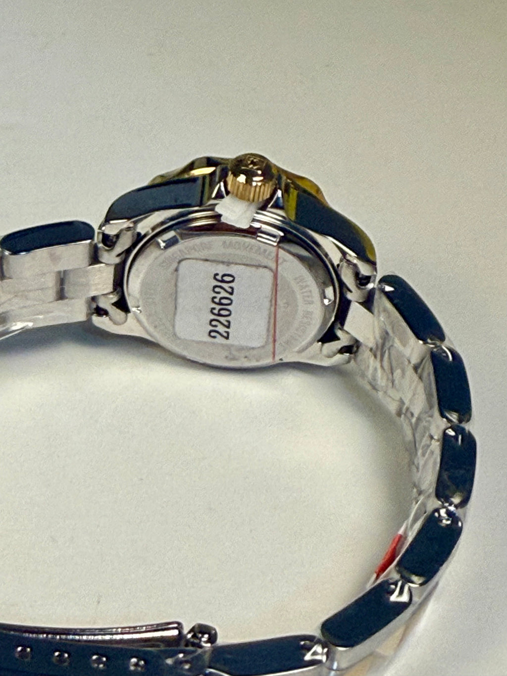 Close-up of aLadies Invicta Pro Diver 24.5 mm watch with a blue strap and silver case on a white background