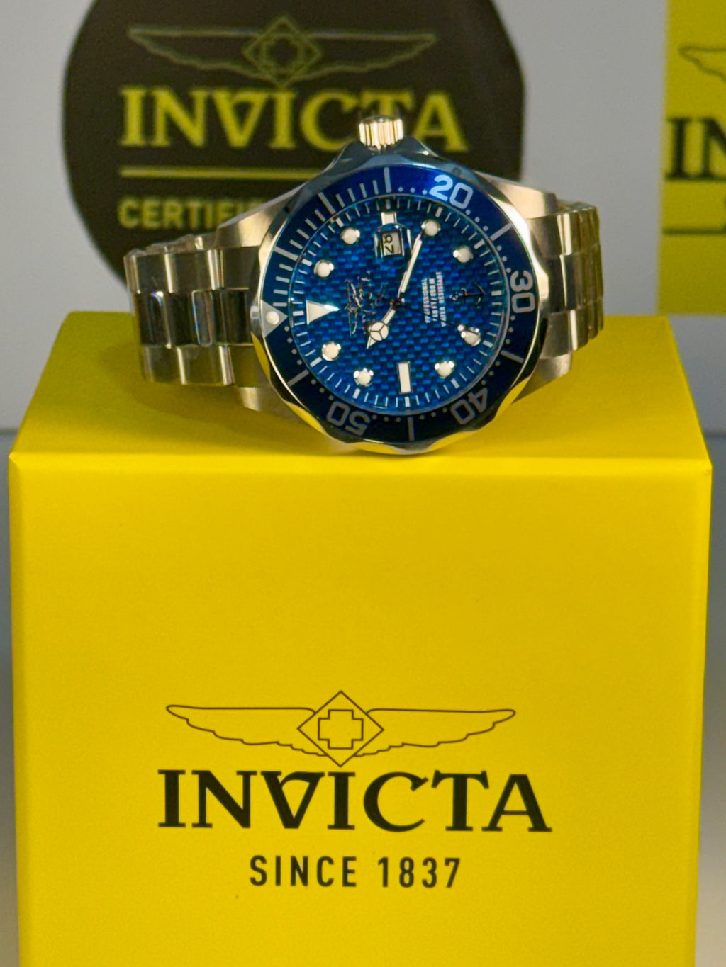 Invicta 47 mm Ocean Voyage watch on a yellow box with Invicta branding