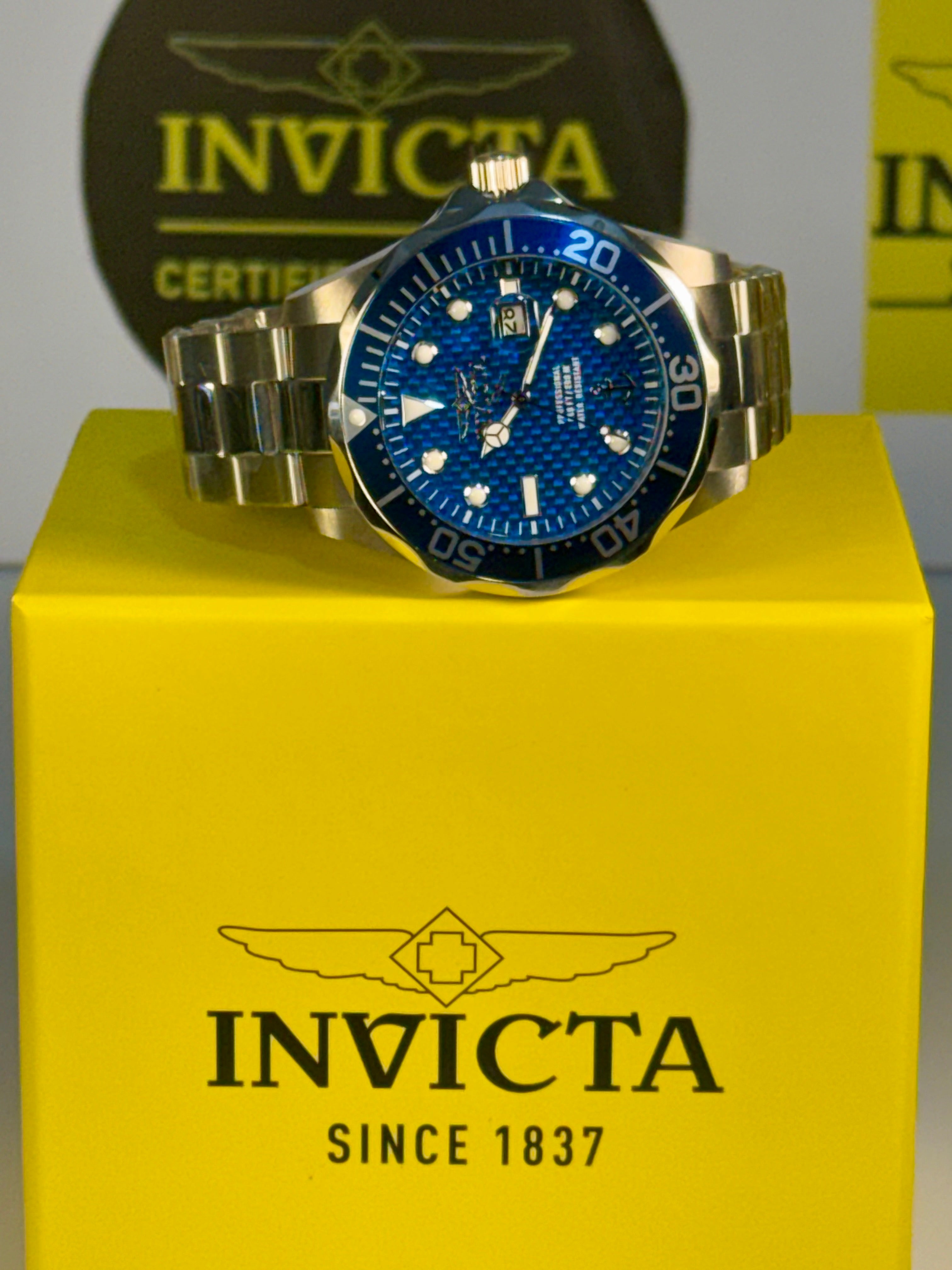 Invicta 47 mm Ocean Voyage watch on a yellow box with Invicta branding